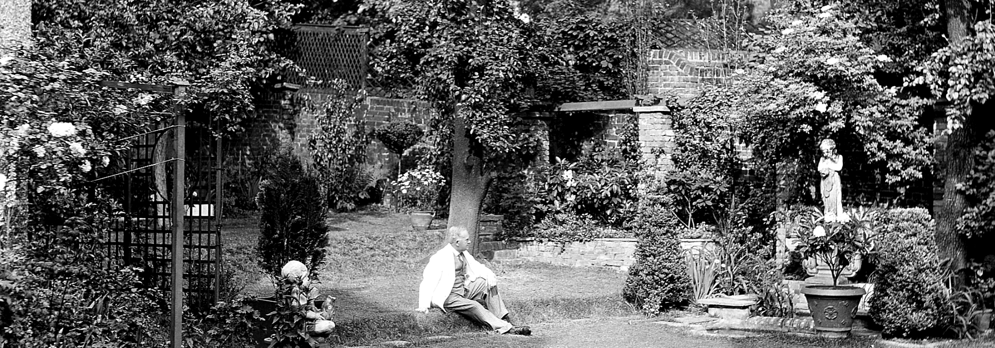 Gilbert Bayes sitting in his garden